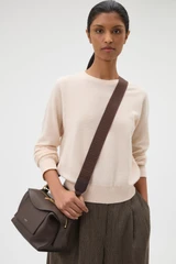 Profile view of model wearing the Oroton Logo Bag Strap in Dark Chocolate and Premium leather and webbing material for Women . IP:2
