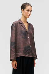 Profile view of model wearing the Oroton Scribble Tree Ls Camp Shirt in Chocolate and 100% silk fabric for Women . IP:4