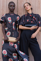 Profile view of model wearing the Oroton WINTER FLORAL DRESS in Black and 100% silk fabric for Women