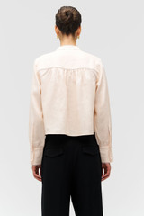 Profile view of model wearing the Oroton Doilie Detail Top in Peach and 100% linen fabric for Women . IP:5