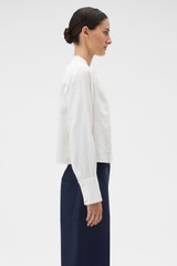 Profile view of model wearing the Oroton Doilie Detail Top in Antique White and 100% linen fabric for Women . IP:3