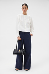 Profile view of model wearing the Oroton Doilie Detail Top in Antique White and 100% linen fabric for Women . IP:6