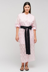 Profile view of model wearing the Oroton Scallop Lace Shirt Dress in Pink Rose and 85% Tencel 15% Polyester Material for Women