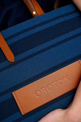 Profile view of model wearing the Oroton Sasha Small Tote in PRUSSIAN BLUE MIX and 100% polyester fabric for Women . IP:5