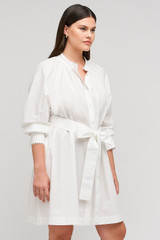 Profile view of model wearing the Oroton Lace Detail Smock Dress in White and 100% cotton material for Women