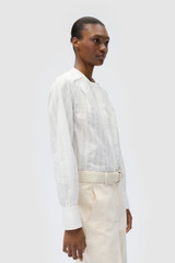 Profile view of model wearing the Oroton TEXTURED STRIPE BLOUSE in Antique White and 100% cotton fabric for Women
