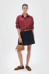 Profile view of model wearing the Oroton Wren Poplin Shirt in Rouge and Made from 100% poplin cotton  for Women