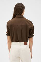 Profile view of model wearing the Oroton Wren Poplin Shirt in Dark Chocolate and 100% cotton fabric for Women . IP:5