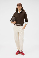 Profile view of model wearing the Oroton Flora Fine Knit Polo in Bitter Chocolate and 55% extra fine merino wool and 45% cotton blend fabric for Women . IP:2