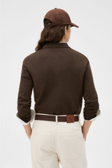 Profile view of model wearing the Oroton Flora Fine Knit Polo in Bitter Chocolate and 55% extra fine merino wool and 45% cotton blend fabric for Women . IP:5