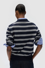 Profile view of model wearing the Oroton FLORA FINE KNIT STRIPE POLO in North Sea and 55% extra fine merino wool and 45% cotton blend fabric for Women . IP:5
