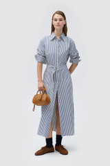 Profile view of model wearing the Oroton WREN STRIPE DRESS in North Sea and 100% yarn-dyed cotton fabric for Women