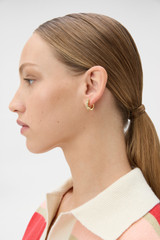 Profile view of model wearing the Oroton Jenna Huggies in Gold/Crystal and Premium brass material for Women . IP:2