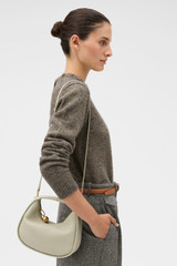 Profile view of model wearing the Oroton Clara Mini Bag in FUDGE and  for Women . IP:4