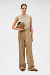 Profile view of model wearing the Oroton Pleat Pant in Hazelnut and 97% wool and 3% spandex blend fabric for Women .