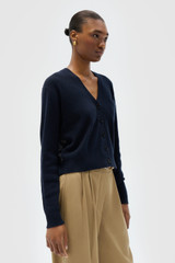 Profile view of model wearing the Oroton Silk Detail Cardigan in North Sea and 98% lambswool and 2% nylon blend fabric for Women . IP:4