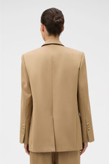 Profile view of model wearing the Oroton Db Blazer in Hazelnut and 97% wool and 3% spandex blend fabric for Women . IP:5