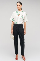 Profile view of model wearing the Oroton Rosebud Tie Neck Blouse in Antique White and 100% silk material for Women . IP:2