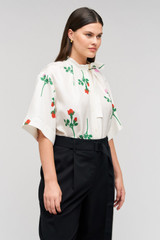Profile view of model wearing the Oroton Rosebud Tie Neck Blouse in Antique White and 100% silk material for Women