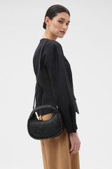 Profile view of model wearing the Oroton Clara Straw Mini Bag in Black and Woven straw material for Women . IP:3