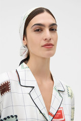 Profile view of model wearing the Oroton Label Print Silk Scarf in White and 100% silk twill fabric for Women . IP:3