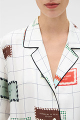 Profile view of model wearing the Oroton Label Print Camp Shirt in Cream and 100% silk twill fabric for Women . IP:5