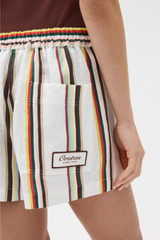 Profile view of model wearing the Oroton FIESTA STRIPE SHORTS in Multi and 100% linen fabric for Women .
