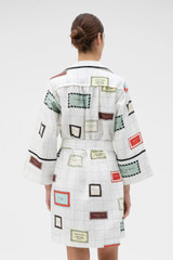 Profile view of model wearing the Oroton Vintage Label Print Tunic Dress in Cream and 100%  linen fabric for Women . IP:5