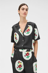 Profile view of model wearing the Oroton Folk Doilie Camp Shirt in Black and 100% silk twill fabric for Women . IP:2