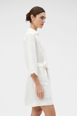 Profile view of model wearing the Oroton Handkerchief Tunic Dress in Antique White and 100% mid-weight linen fabric for Women . IP:4