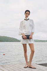 Profile view of model wearing the Oroton Handkerchief Tunic Dress in Antique White and 100% mid-weight linen fabric for Women . IP:6