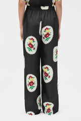 Profile view of model wearing the Oroton Folk Doilie Print Pyjama Pant in Black and 100% silk twill fabric for Women . IP:5