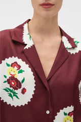 Profile view of model wearing the Oroton Folk Doilie Camp Shirt in Burgundy and 100% silk twill fabric for Women .