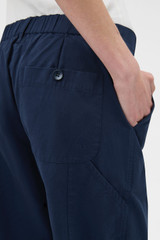 Profile view of model wearing the Oroton Arlo Carpenter Chino in NORTH SEA and 100% cotton fabric for Women . IP:5
