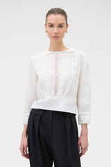 Profile view of model wearing the Oroton LACE DETAIL BLOUSE in ANTIQUE WHITE and 100% lightweight linen fabric for Women