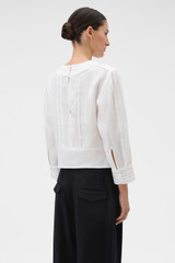 Profile view of model wearing the Oroton Lace Detail Blouse in Antique White and 100% linen fabric for Women . IP:3