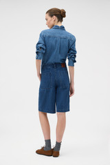 Profile view of model wearing the Oroton  Denim Bermuda in DENIM and 90% cotton and 10% polyester blend fabric for Women . IP:4