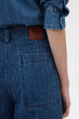 Profile view of model wearing the Oroton  Denim Bermuda in DENIM and 90% cotton and 10% polyester blend fabric for Women . IP:6