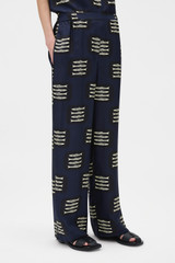 Profile view of model wearing the Oroton Marine Fish Pyjama Pant in NORTH SEA and 100% lightweight fluid silk twill fabric with a fine weave for Women . IP:3