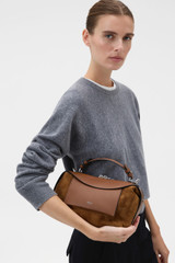Profile view of model wearing the Oroton Mica Mini Bowler in Teak and Premium suede leather for Women . IP:3