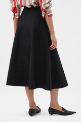 Profile view of model wearing the Oroton Zip Midi Skirt in BLACK and 100% heavyweight linen fabric for Women . IP:4