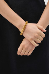 Profile view of model wearing the Oroton Romy Bracelet in WORN GOLD and Premium brass material for Women . IP:2