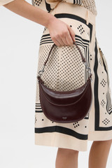 Profile view of model wearing the Oroton Florence Small Shoulder Bag in COPPER and Premium crackle leather for Women . IP:4