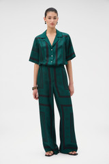 Profile view of model wearing the Oroton SPOT SCARF PRINT TROUSER in HELM GREEN and 100% silk twill fabric for Women . IP:2