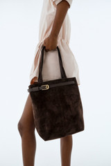 Profile view of model wearing the Oroton Cali Tote Suede in Dark Chocolate and Premium suede leather for Women .