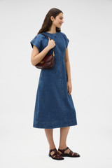 Profile view of model wearing the Oroton Denim Dress in Denim and 100% cotton fabric for Women . IP:6