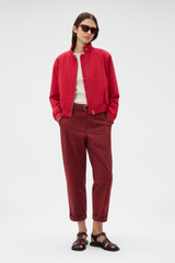 Profile view of model wearing the Oroton Knit Trim Bomber in Cerise and 100% cotton fabric for Women . IP:6