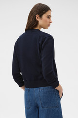 Profile view of model wearing the Oroton Cotton Knit Cardigan in North Sea and 100% cotton fabric for Women . IP:5