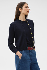 Profile view of model wearing the Oroton Cotton Knit Cardigan in North Sea and 100% cotton fabric for Women . IP:3