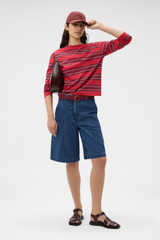 Profile view of model wearing the Oroton Long Sleeve Stripe Tee in Market Red and 100% cotton fabric for Women . IP:6